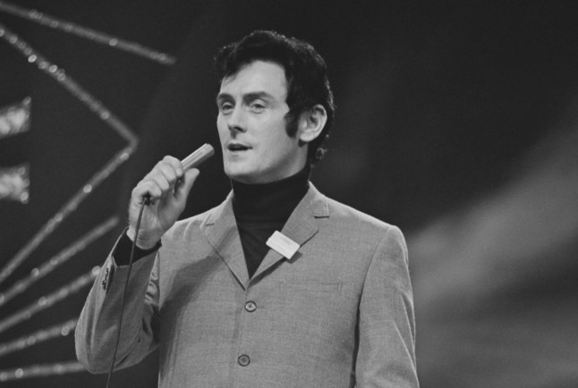 Irish singer Pat McGuigan singing into a microphone