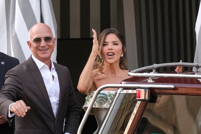 Jeff Bezos, left, and Lauren Sanchez leave a hotel for their pre wedding reception, in Venice, Italy, Thursday, June 26, 2025. (AP Photo/Luca Bruno)