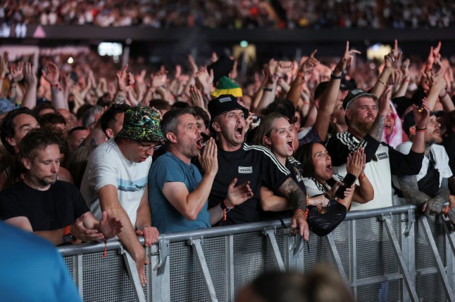 Fans react as Oasis perform, during the first of their sellout comeback shows, at the Cardiff Principality Stadium, in Cardiff, Wales, Britain, July 4, 2025. REUTERS/Suzanne Plunkett NO RESALES. NO ARCHIVES. NO USE AFTER 365 DAYS AFTER PUBLICATION. PHOTOGRAPHS MAY BE PUBLISHED IN CONTEXT WITH THE SHOW ONLY.