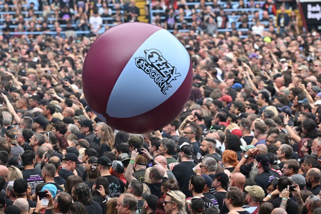 The Villa Park crowd plays with a huge beach ball as they watch support acts, during British rock band Black Sabbath's "Back to The Beginning" concert, Ozzy Osbourne's final ever gig as Black Sabbath's frontman at Villa Park in Birmingham, central England on July 5, 2025. Osbourne, who revealed in 2020 that he has Parkinson's disease, will join Tony Iommi, Geezer Butler and Bill Ward for the all-day "Back To The Beginning" show in Birmingham, central England, where the heavy metal giants formed in 1968. (Photo by ANDY BUCHANAN / AFP) (Photo by ANDY BUCHANAN/AFP via Getty Images)