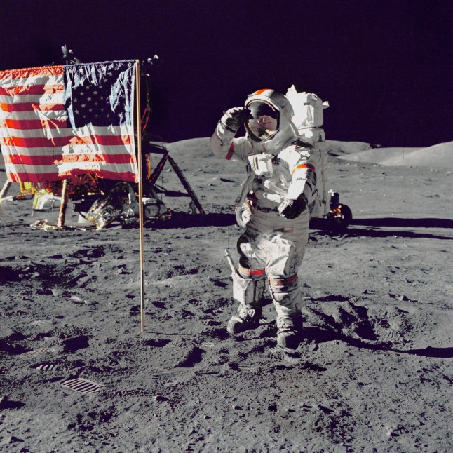 EARTH The Moon -- 13 Dec 1972 -- US astronaut Eugene Cernan, Commander, Apollo 17 salutes the flag on the lunar surface during extravehicular activity (EVA) on NASA's final lunar landing mission. The Lunar Module "Challenger" is in the left background behind the flag and the Lunar Roving Vehicle (LRV) also in background behind him. While astronauts Cernan and Schmitt descended in the Challenger to explore the Taurus-Littrow region of the Moon, astronaut Ronald E. Evans, Command Module pilot, remained with the Command/Service Module (CSM) "America" in lunar-orbit -- Picture by Lightroom Photos / NASA