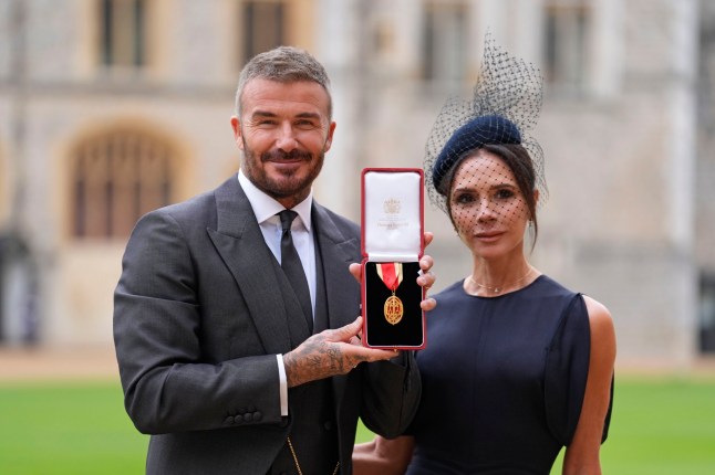 WINDSOR, ENGLAND - NOVEMBER 4: Sir David Beckham poses with his wife Lady Victoria after he was made a Knight Bachelor at an investiture ceremony at Windsor Castle on November 4, 2025 in Windsor, England. (Photo by Andrew Matthews - Pool/Getty Images)