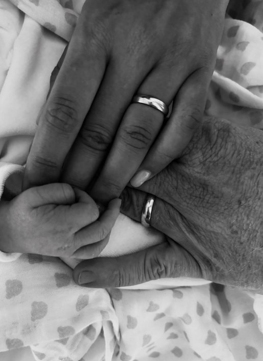 Black and white picture of Boris and Lilian Becker holding their baby's hand